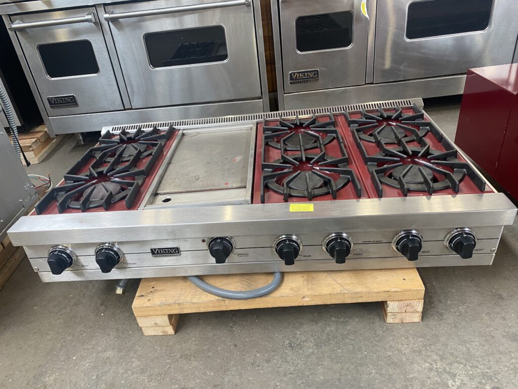 Salvaged Viking Professional stainless steel range top with six burners and griddle, a premium secondhand kitchen appliance for sustainable home or commercial use from our Baltimore non-profit.